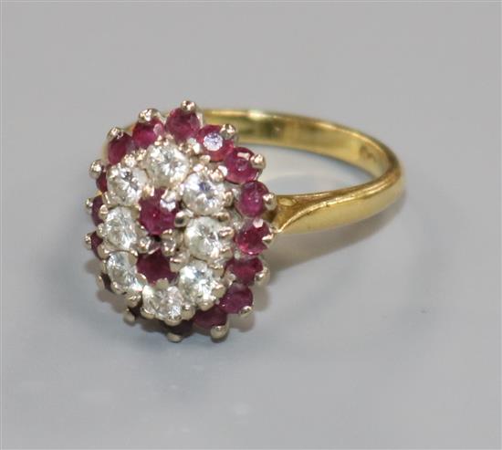 An 18ct gold, ruby and diamond cluster dress ring, size M/N.